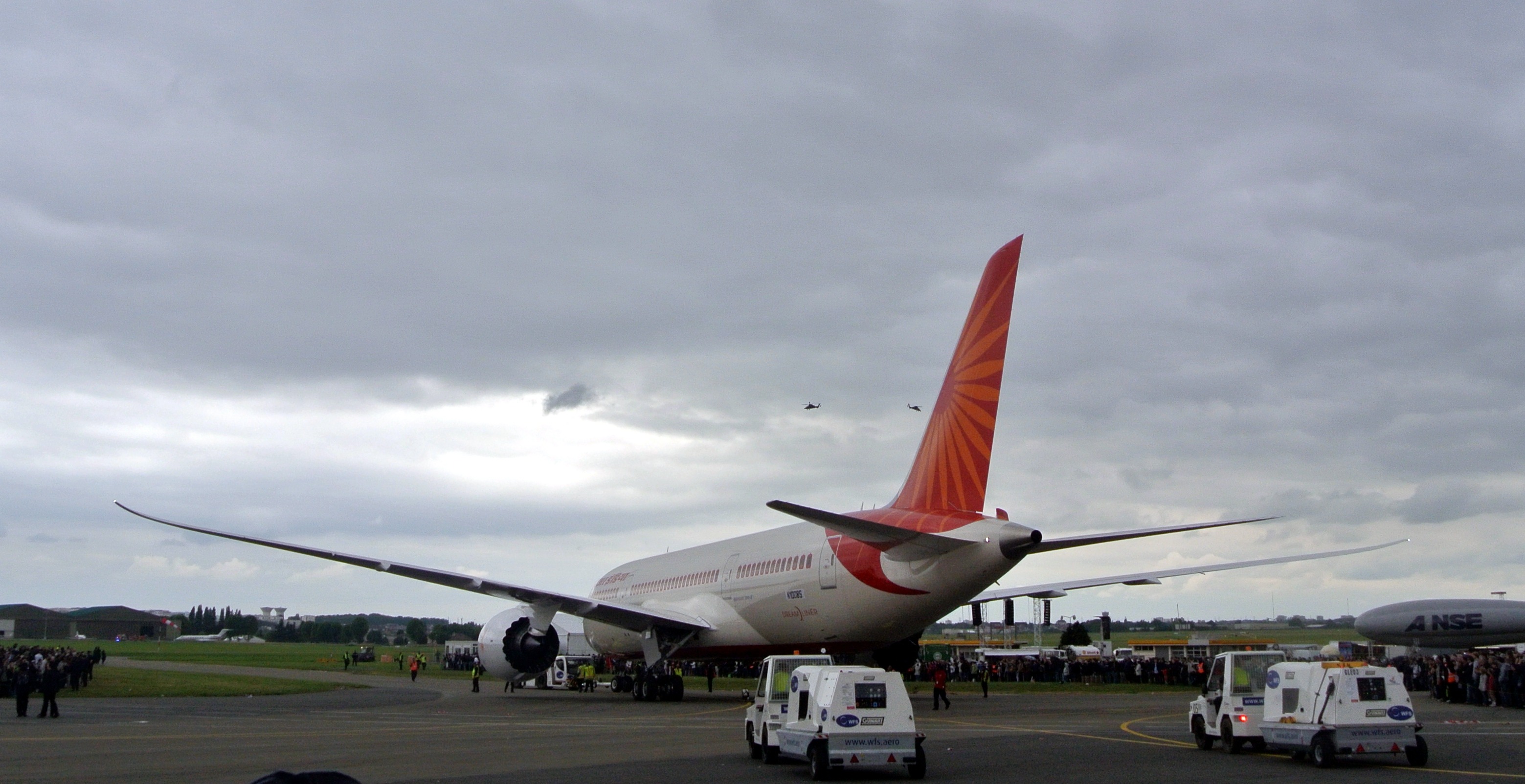 An Air India Boeing 787-8 Dreamliner on the tarmac, being towed toward the runway