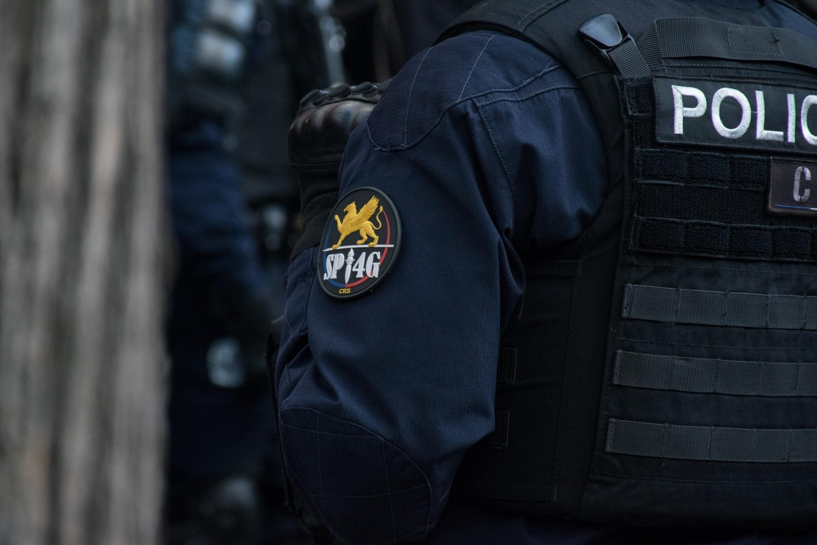 Student demonstrators march in Paris during the October 2026 nationwide protests, with CRS riot police alongside the procession
