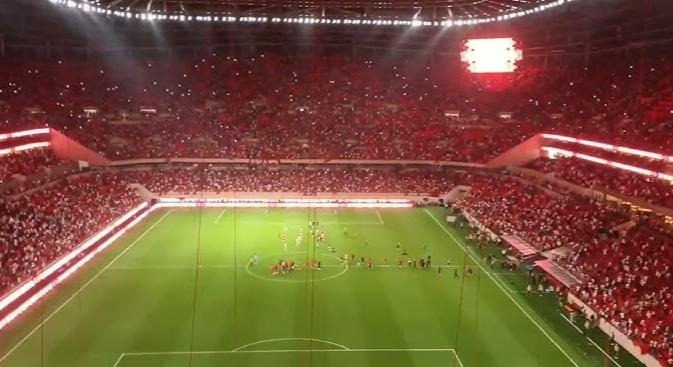 A packed football stadium lit up at night during a match, used as an illustrative image for this report