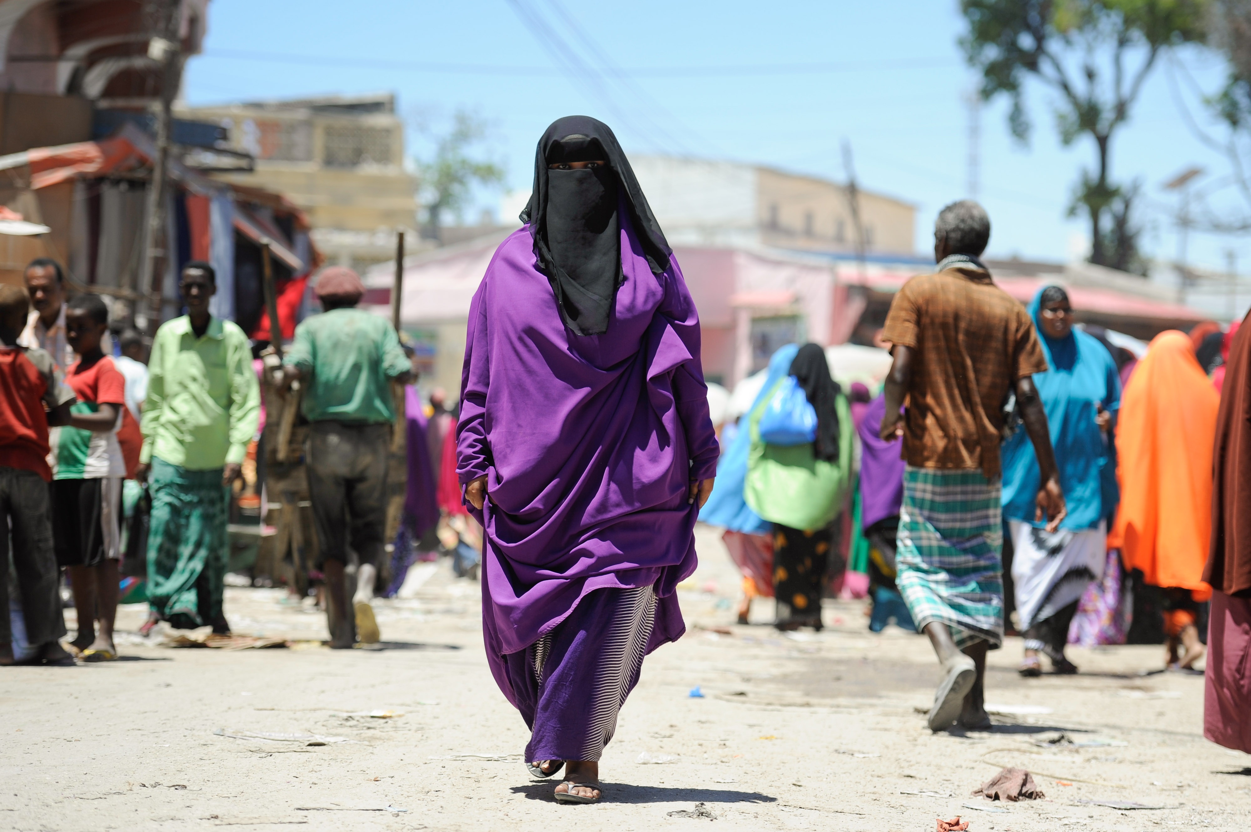 A Somali woman walks down a street in Mogadishu's Hamar Weyne market, Somalia
