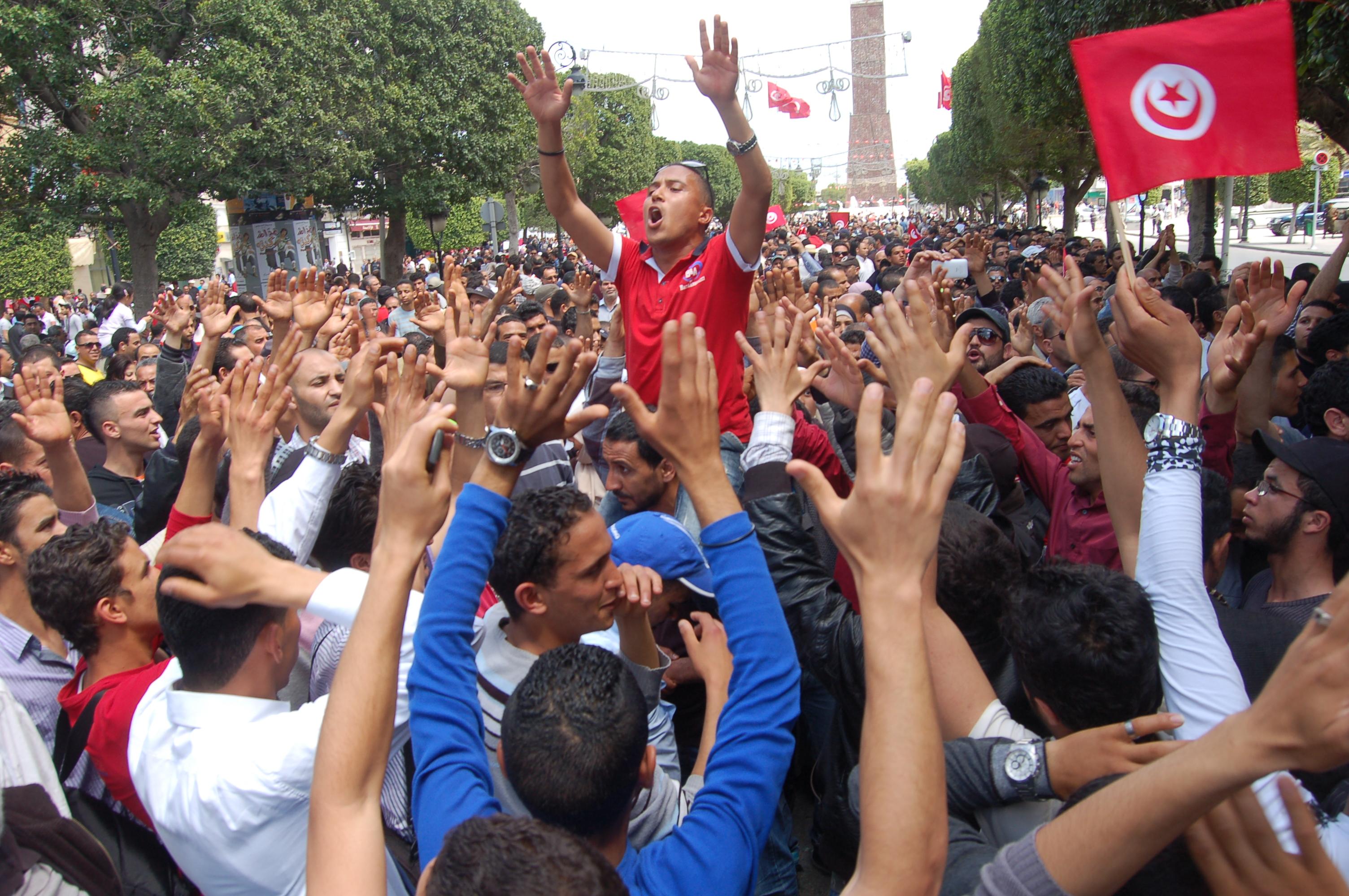 Demonstrators wave Tunisian flags during a protest march on Habib Bourguiba Avenue in Tunis (file photo).