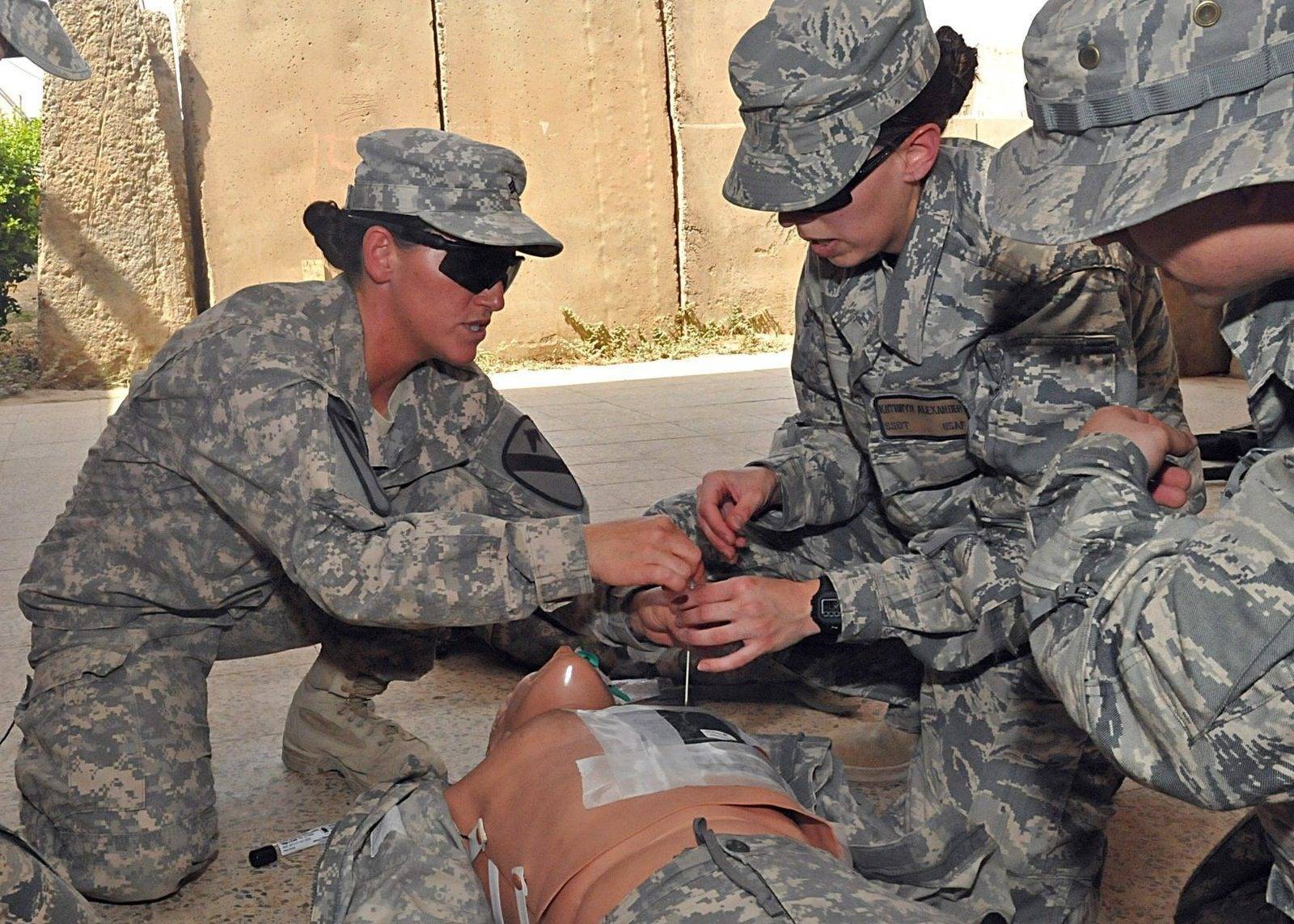 US personnel at a base in Iraq — Sgt. Brenda Goode, a combat medic, assisting airmen at Contingency Operating Site Marez